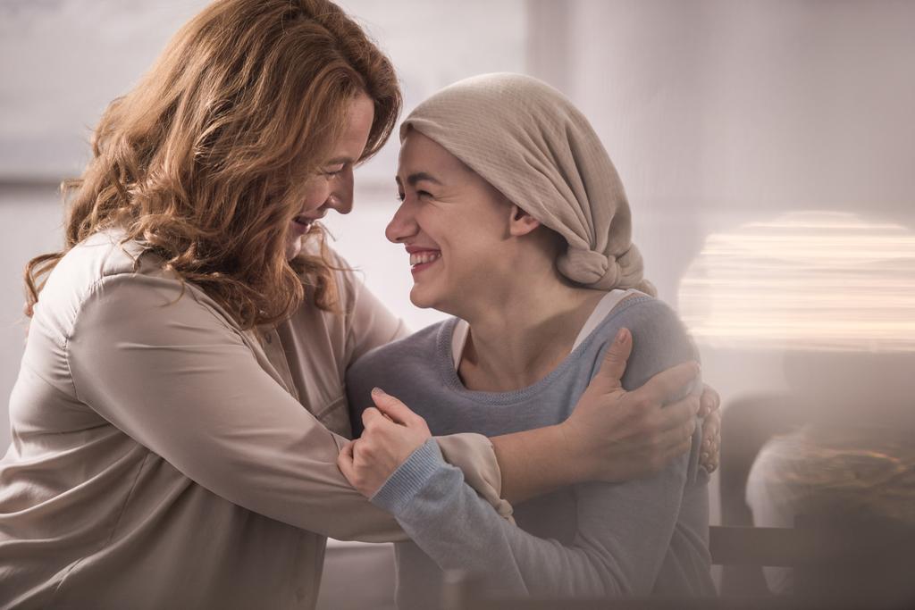 ευτυχισμένη μητέρα και άρρωστος ενηλίκων κόρη το μαντήλι αγκάλιασμα και βλέπουν ο ένας τον άλλον - Φωτογραφία, εικόνα