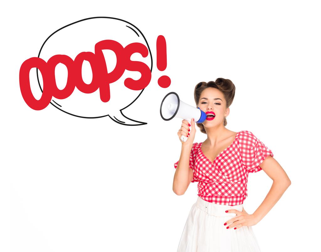 portrait of fashionable young woman in pin up style clothing with oops speech bubble out of loudspeaker isolated on white - Photo, Image