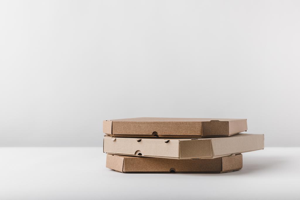 three pizza boxes on white tabletop - Photo, Image