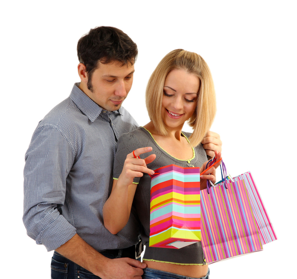 Молода пара купує і тримає багато сумки для покупок ізольовані на білому
 - Фото, зображення