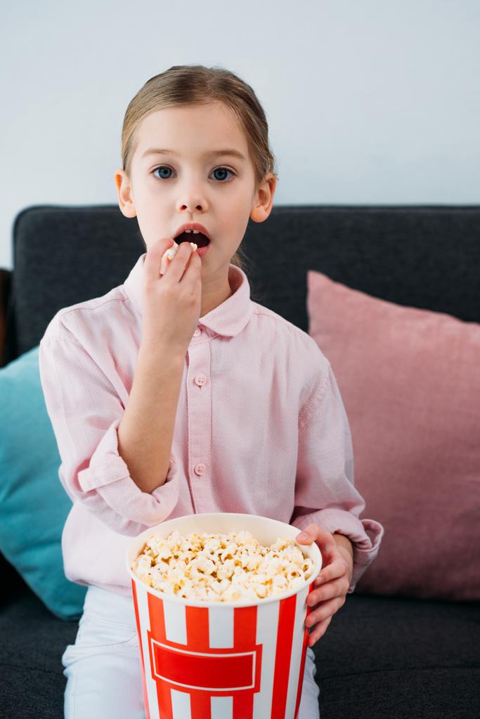 πορτρέτο του παιδί τρώει ποπ κορν και βλέποντας την ταινία στο σπίτι - Φωτογραφία, εικόνα
