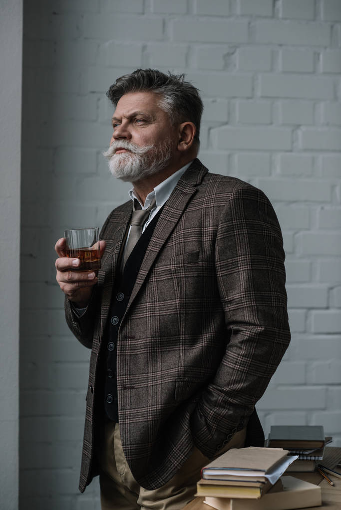 senior man in tweed suit with glass of whiskey looking away - Photo, Image