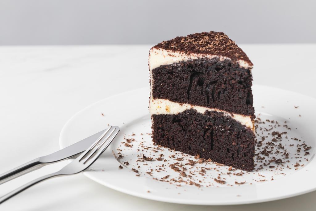 Closeup view of chocolate cake with glaze on white plate - Photo, Image