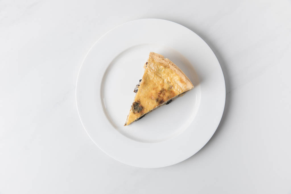 Plate with delicious pie placed on white surface  - Photo, Image