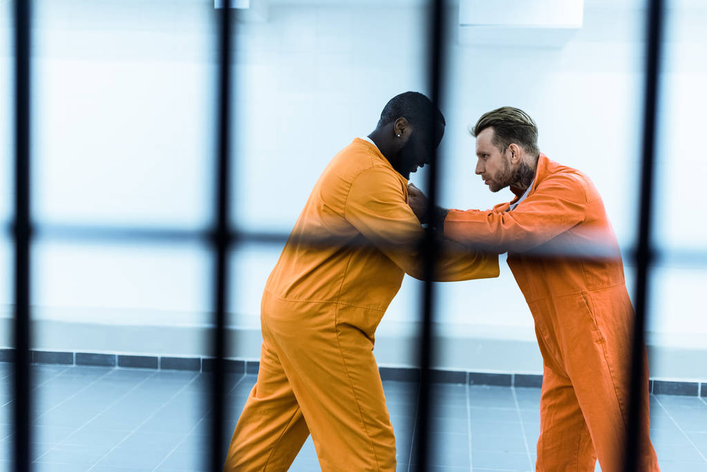 boční pohled mnohonárodnostní vězňů boj za mříže - Fotografie, Obrázek