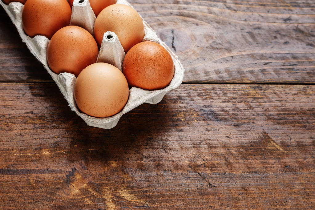 red chicken eggs on a wooden background - Photo, Image
