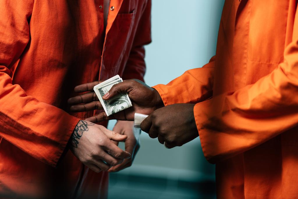 cropped image of prisoner buying drugs at african american inmate - Photo, Image