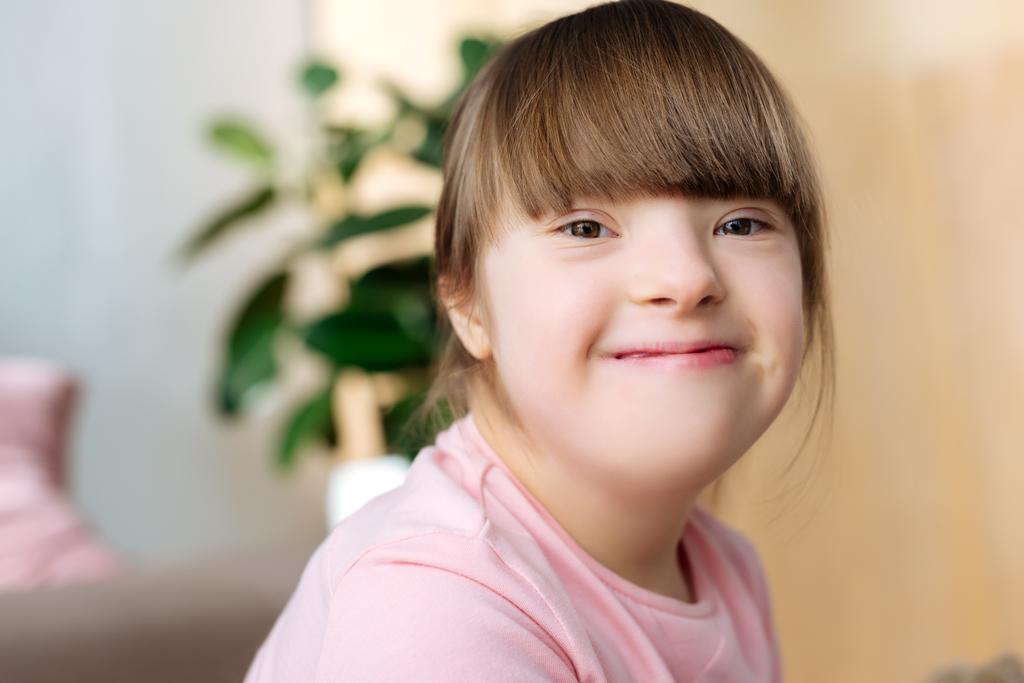 Portrait of smiling kid with down syndrome - Photo, Image