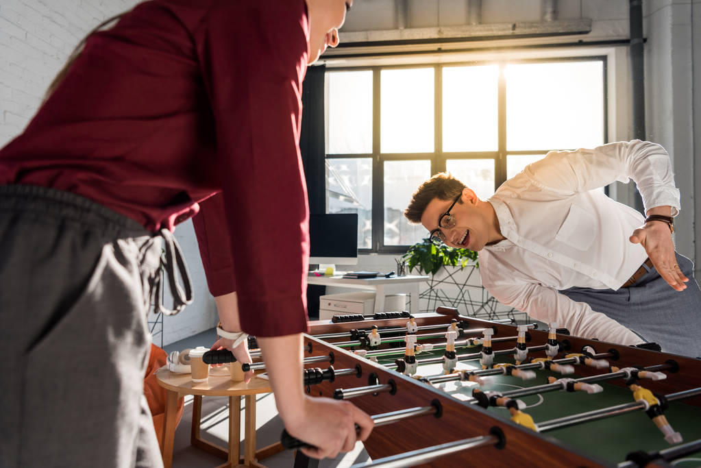happy colleagues playing table football at modern office - Photo, Image