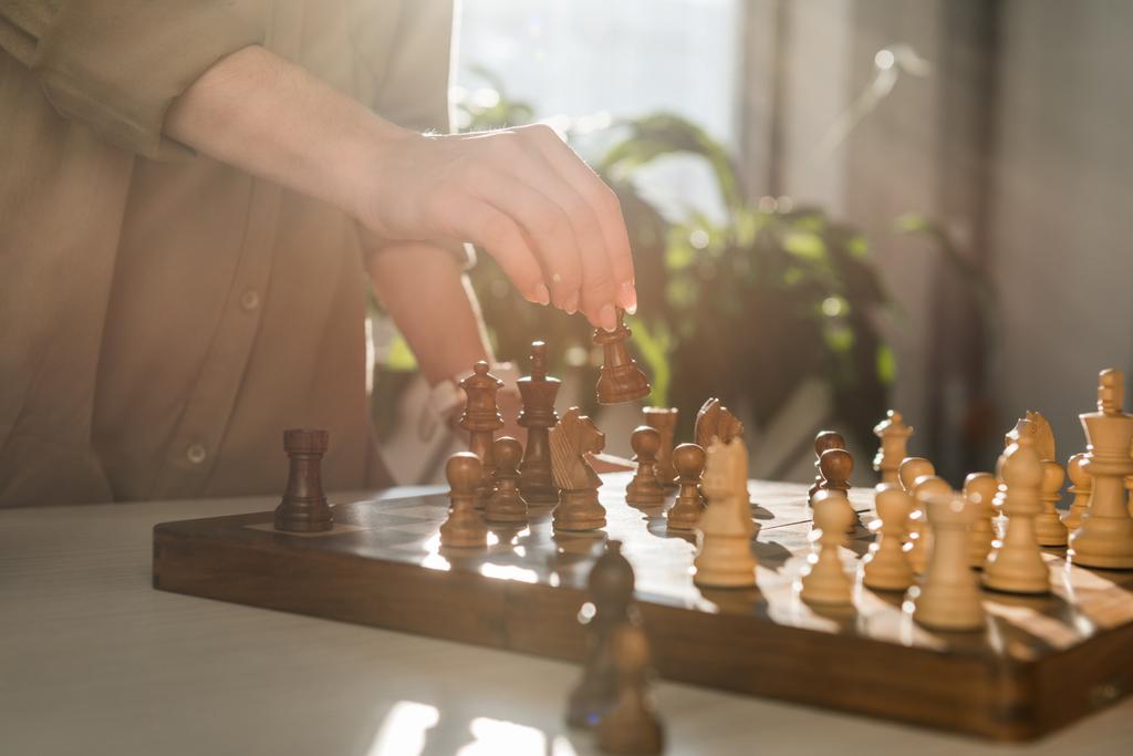 cropped shot of woman making move while playing chess - Photo, Image