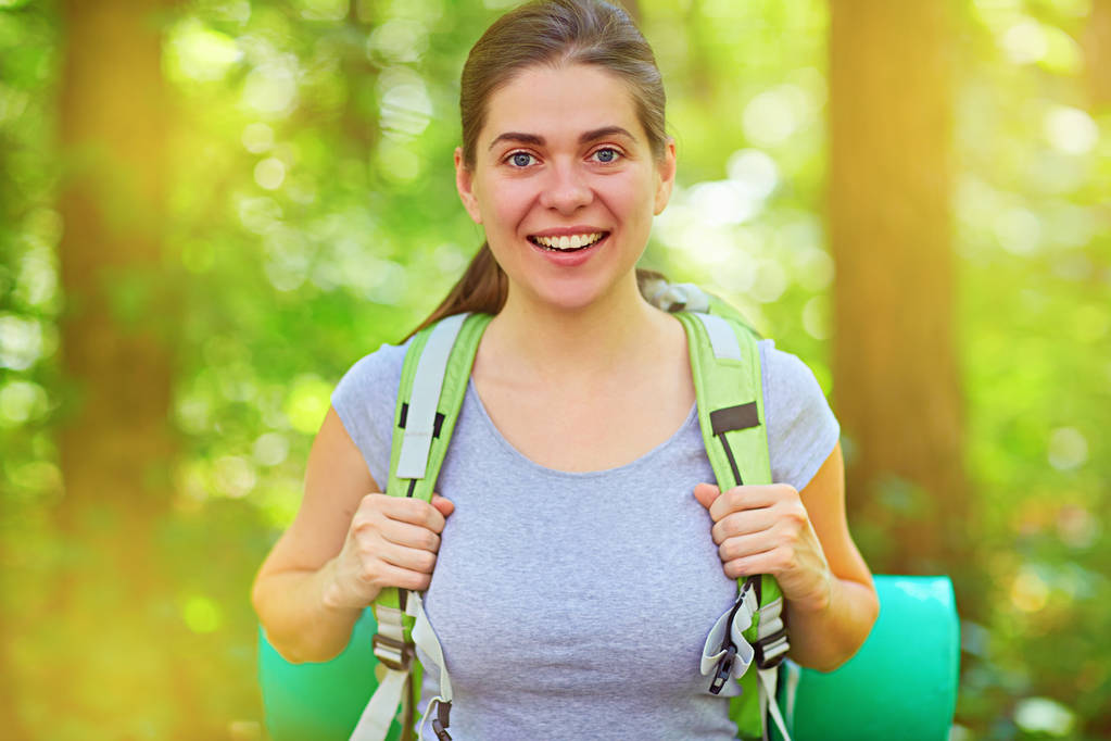 smiling woman hiking tourist with backpack in forest - Photo, Image