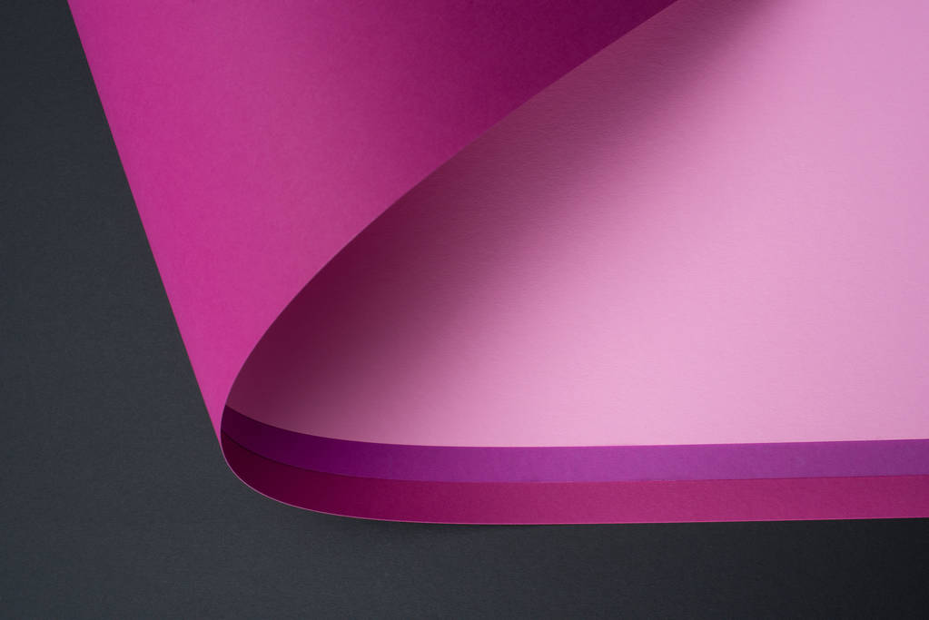roll of purple and pink paper isolated on black - Photo, Image