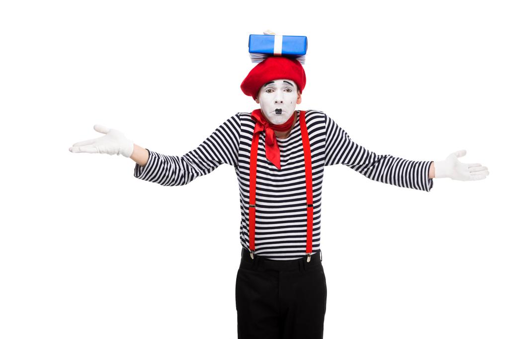 mime showing shrug gesture with gift box on head isolated on white - Photo, Image