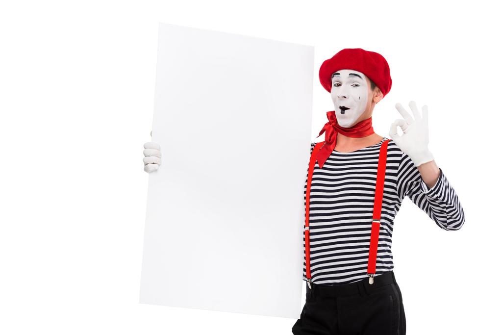 happy mime holding empty board and showing ok sign isolated on white - Photo, Image