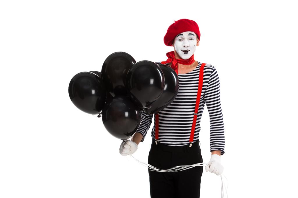 vrolijke mime holding bundel van ballonnen met helium geïsoleerd op wit - Foto, afbeelding
