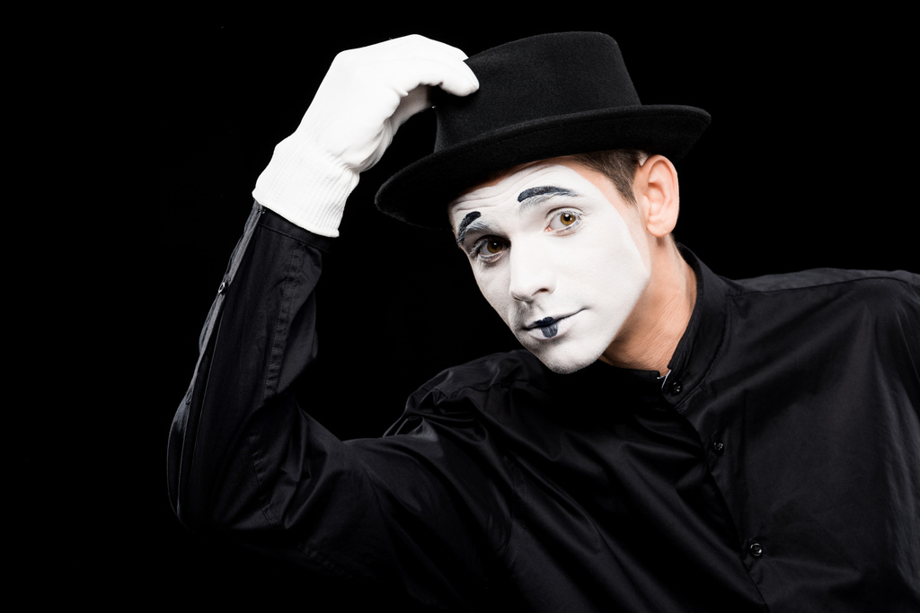 mime greeting and touching hat isolated on black - Photo, Image