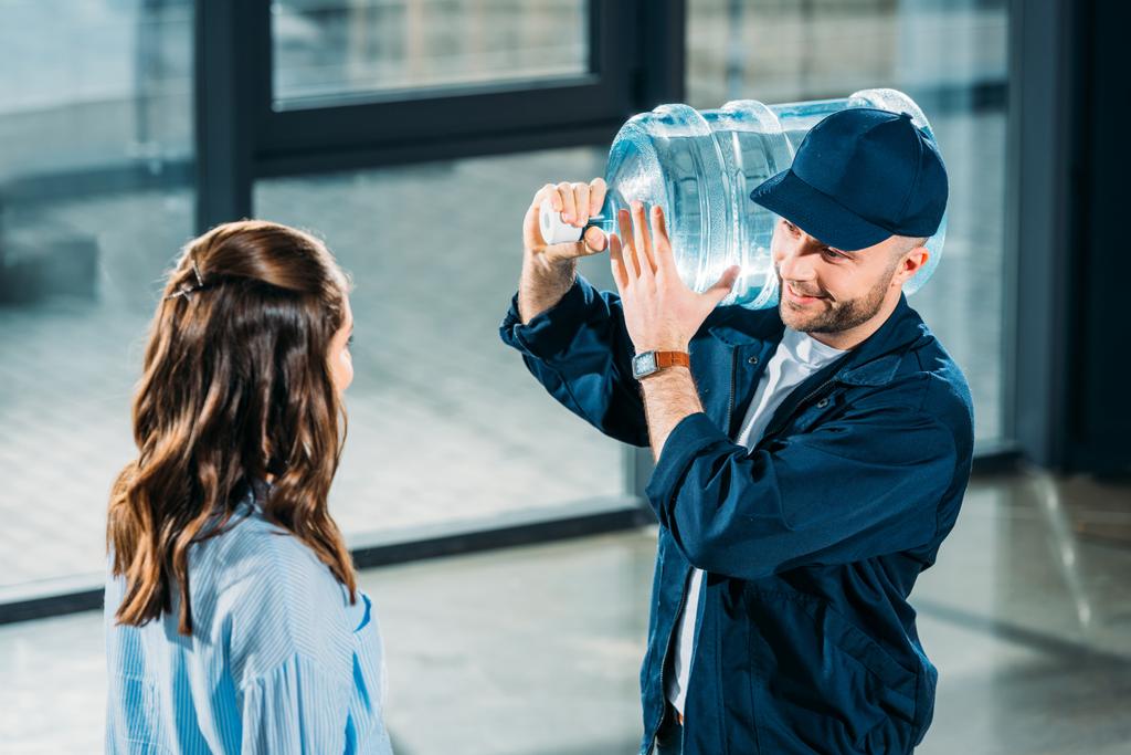 Donna guardando uomo consegna in possesso di bottiglia d'acqua
 - Foto, immagini