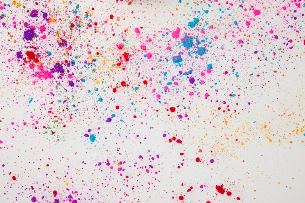 top view of scattered colorful holi powder isolated on white - Photo, Image