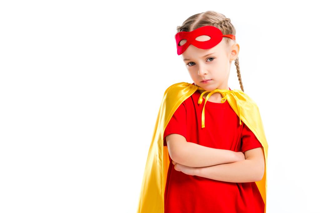 Grumpy little supergirl wearing yellow cape with red mask for eyes on forehead isolated on white - Photo, Image