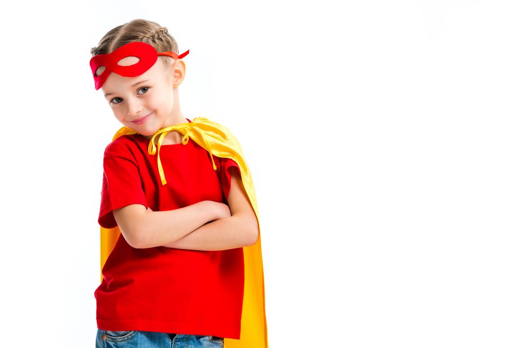 Smiling little supergirl wearing yellow cape with red mask for eyes on forehead isolated on white - Photo, Image