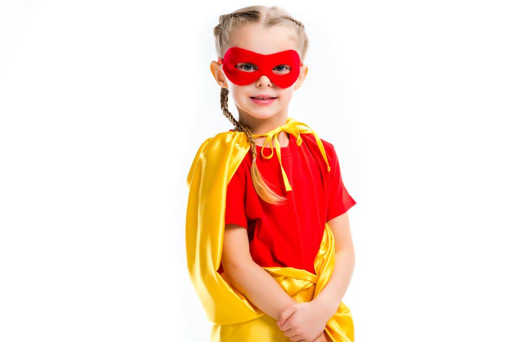 Portrait of little supergirl wearing yellow cape and red mask for eyes isolated on white - Photo, Image