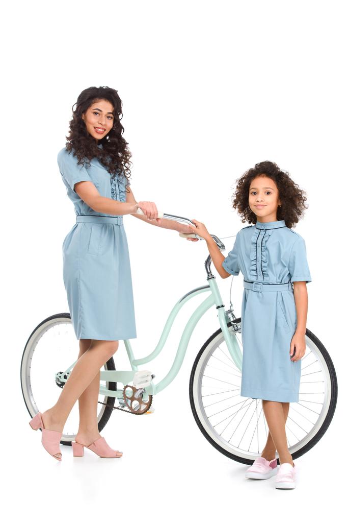 mother and daughter standing with bicycle isolated on white - Photo, Image