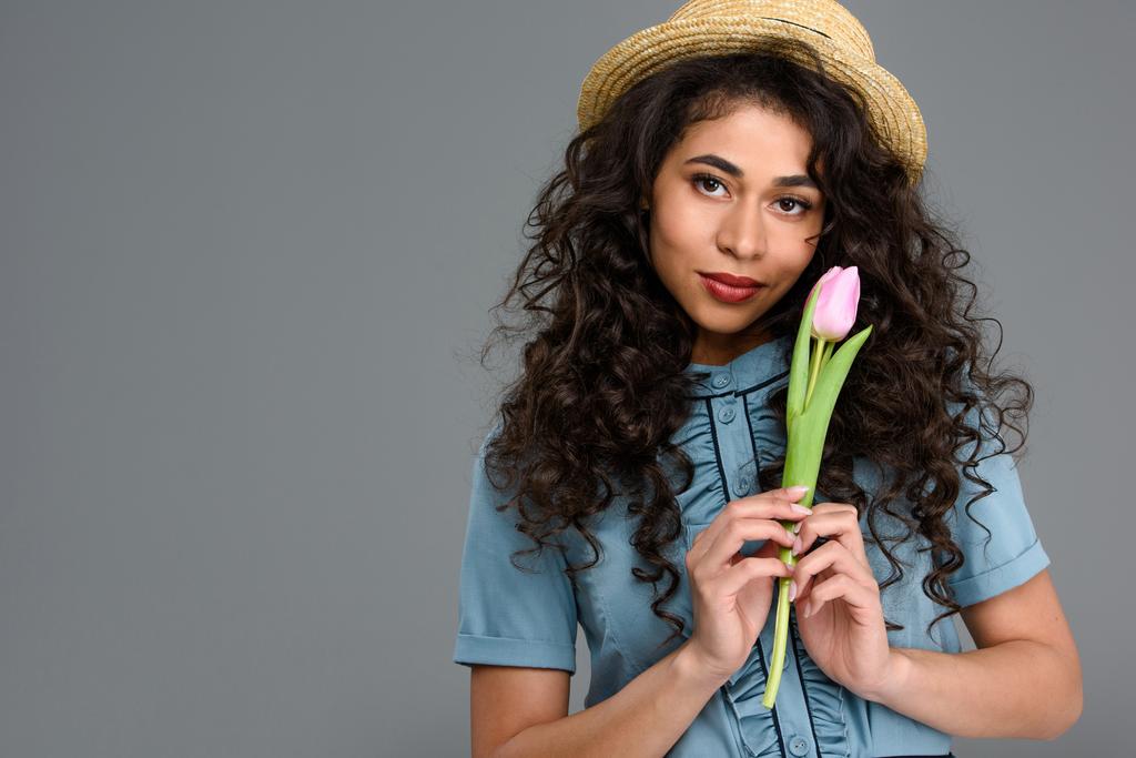 attractive young woman with tulip flower isolated on grey - Photo, Image