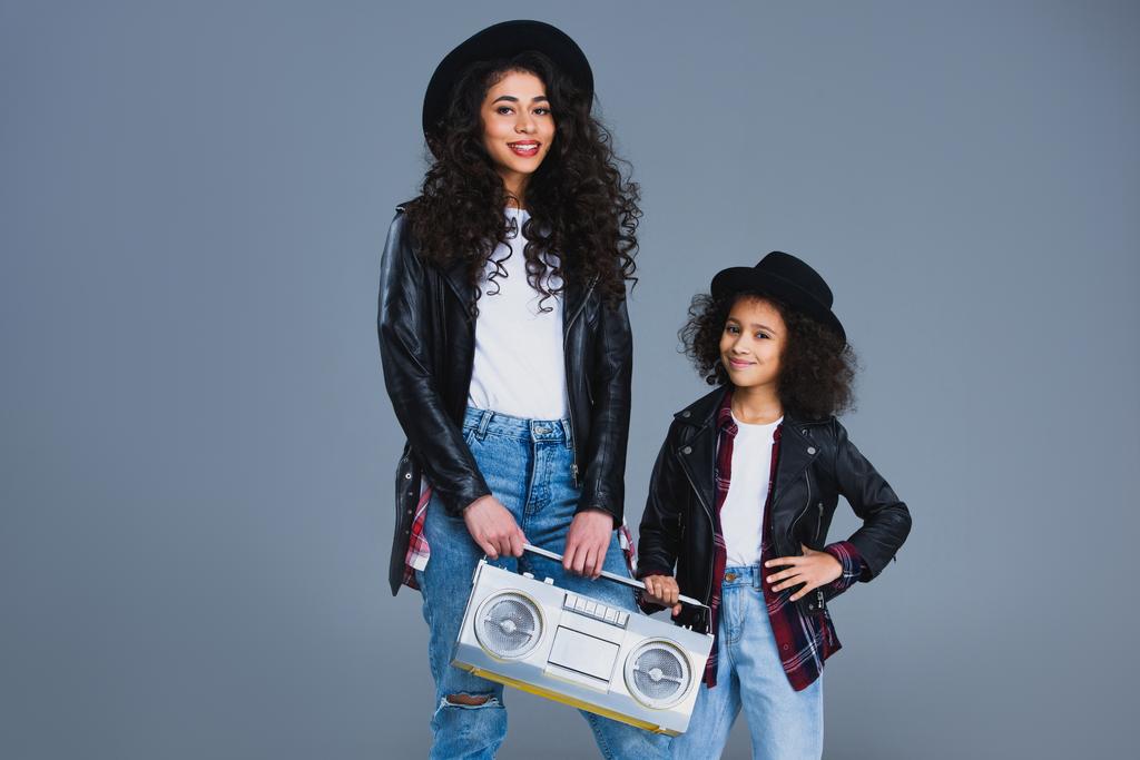mother and daughter with retro boombox isolated on grey - Photo, Image