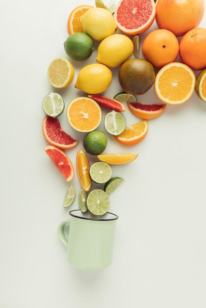 Assorted raw citruses and mug isolated on white background - Photo, Image