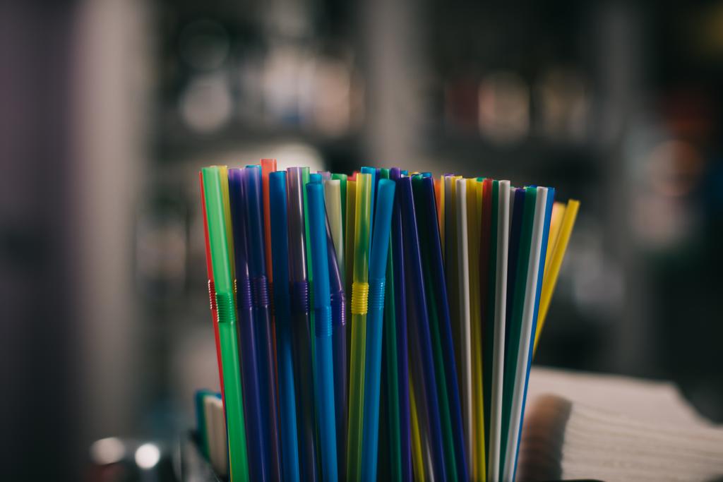 colored plastic straws for drinking on blurred background - Photo, Image