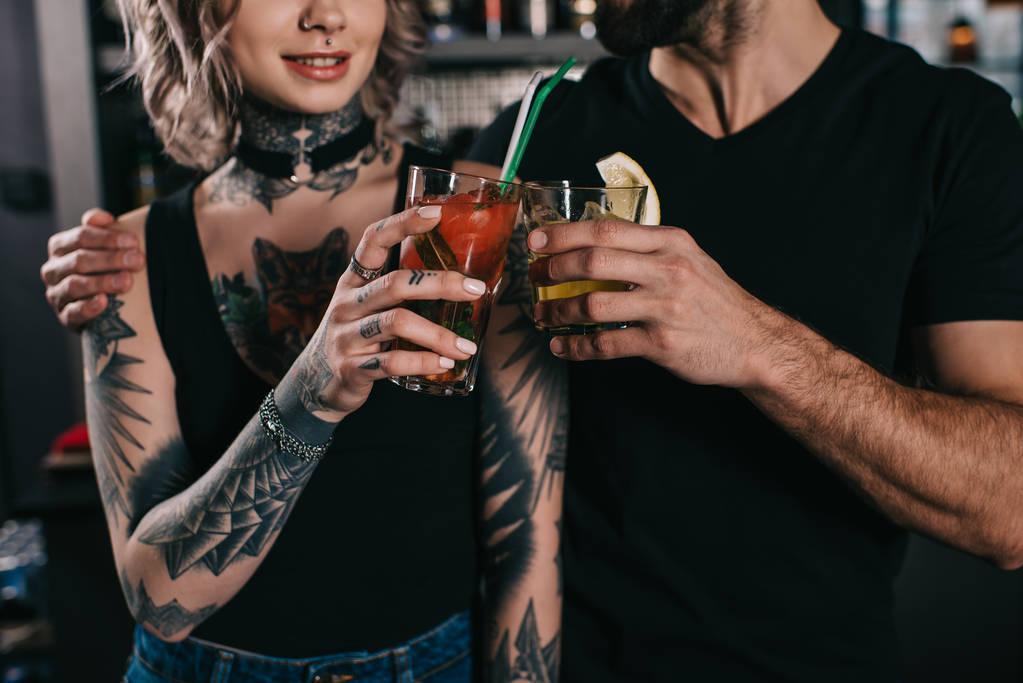 cropped image of bartenders clinking with drinks at bar - Photo, Image
