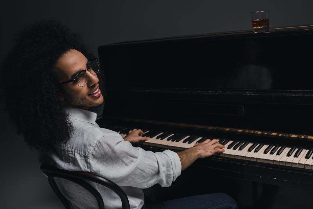 χαμογελαστός νεαρός μουσικός παίζει πιάνο μαύρο - Φωτογραφία, εικόνα