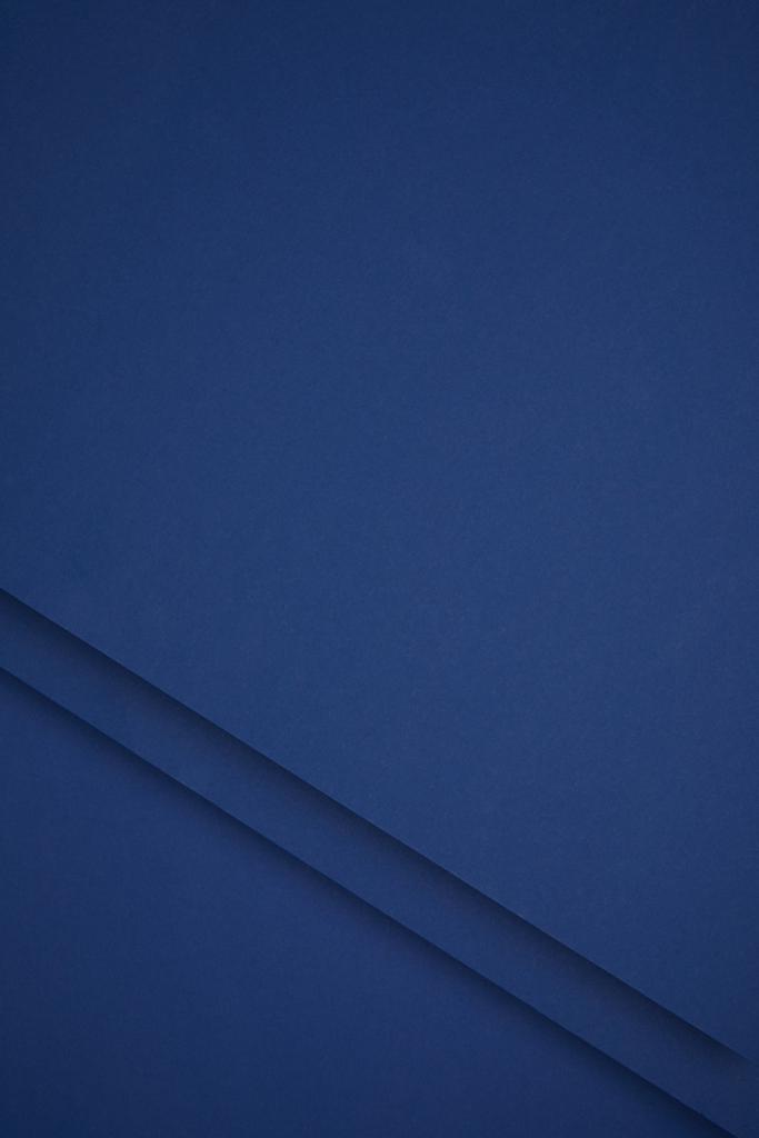 dunkelblauer abstrakter Hintergrund aus farbigem Papier  - Foto, Bild