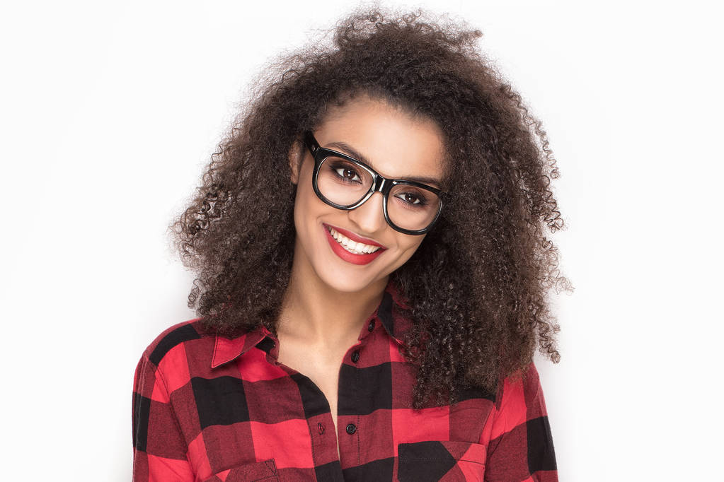 Щаслива дівчина з афро в червоній картатій сорочці
. - Фото, зображення