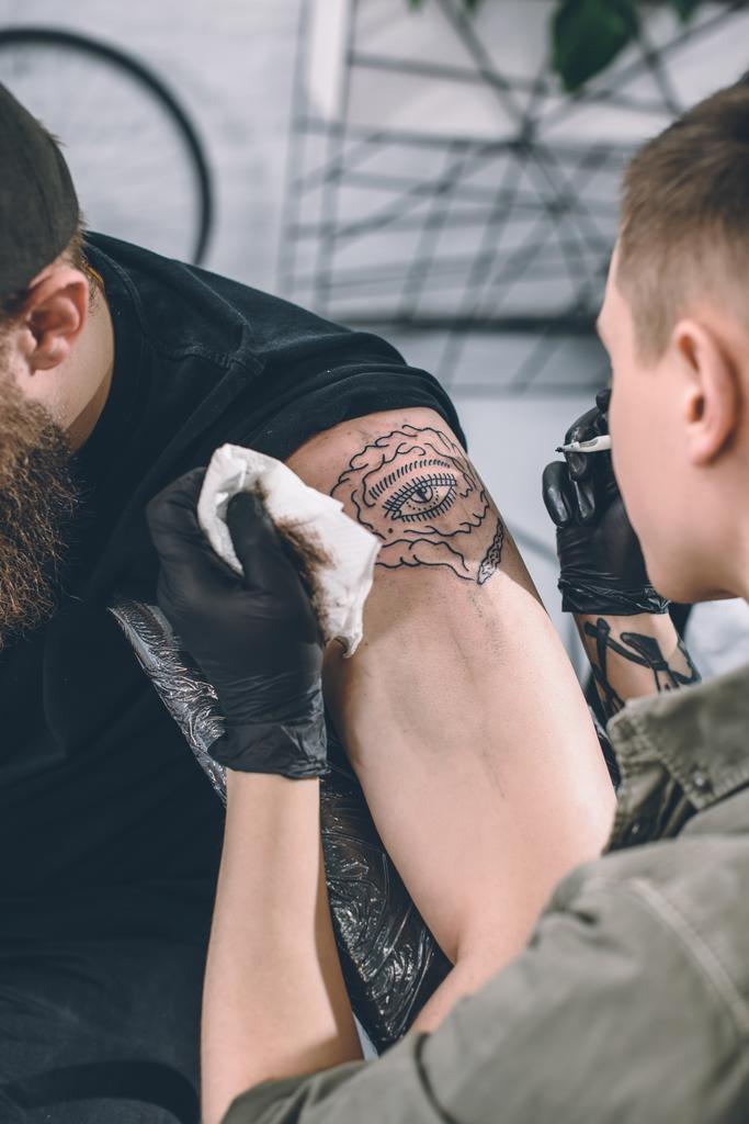 Tatuaje artista trabajando en hombro pieza en estudio
 - Foto, Imagen