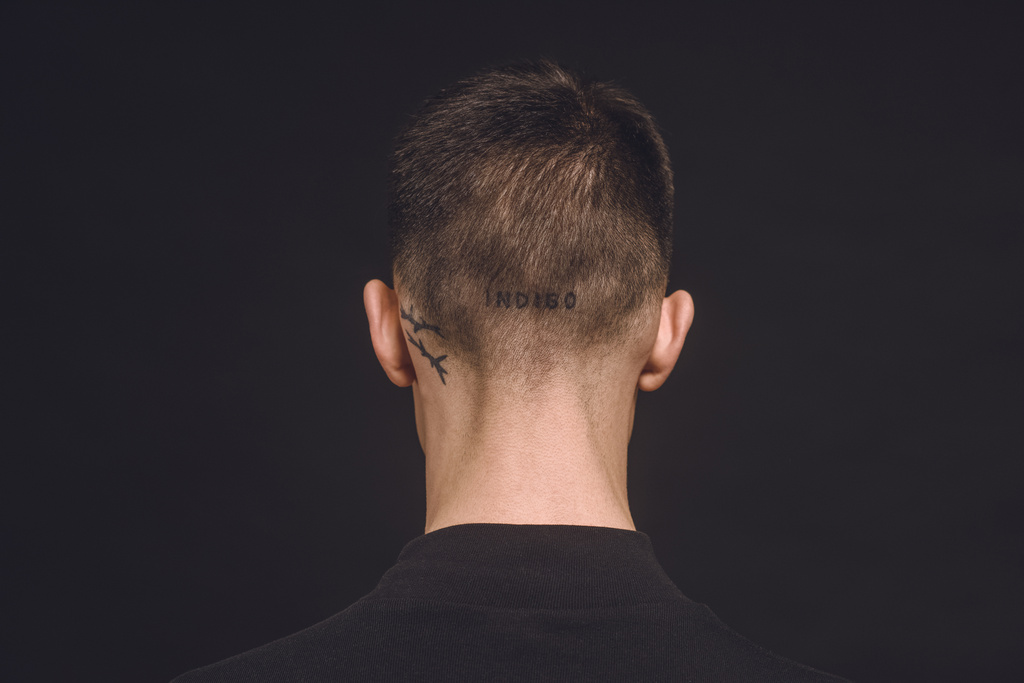 Rear view of tattoos on male neck isolated on black - Photo, Image