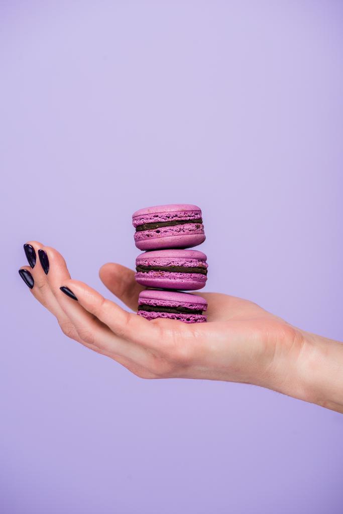 Woman holding macarons isolated on violet - Photo, Image