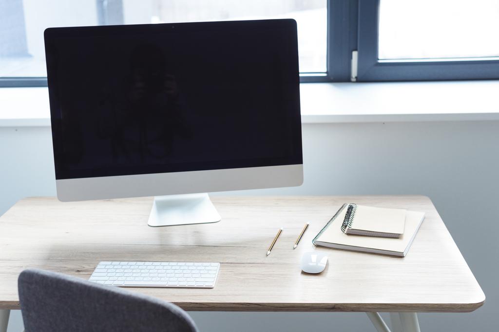 Ordenador con monitor en blanco en la mesa de trabajo
 - Foto, imagen