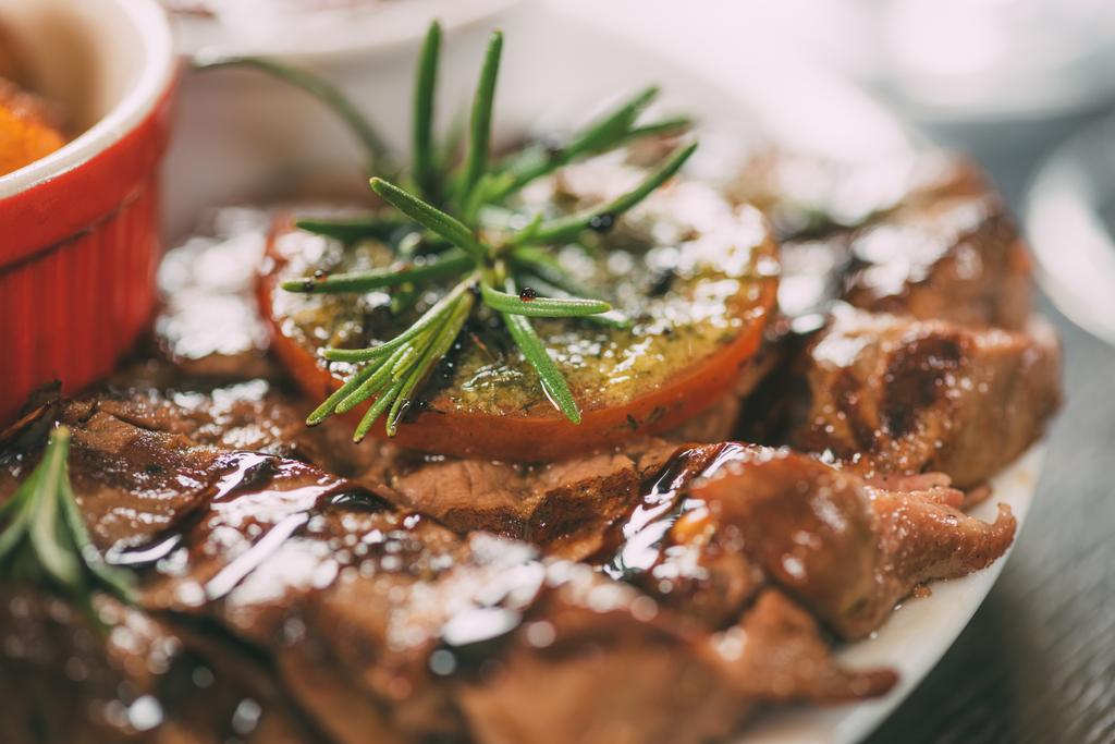 selective focus of delicious grilled chicken with rosemary on plate  - Photo, Image