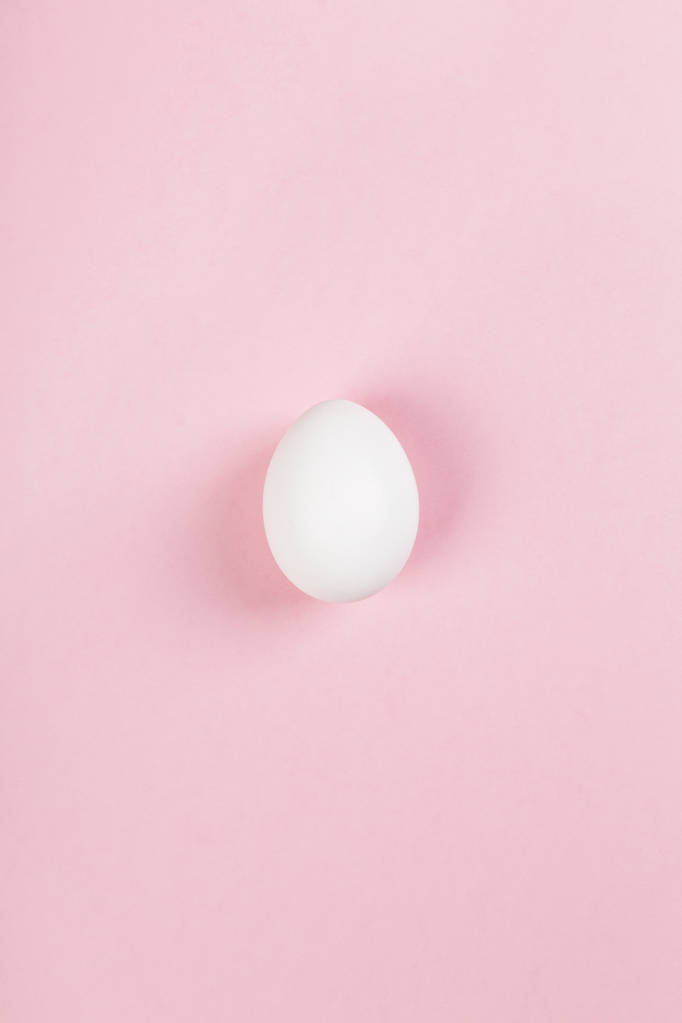 White egg on pink background. Top view - Photo, Image