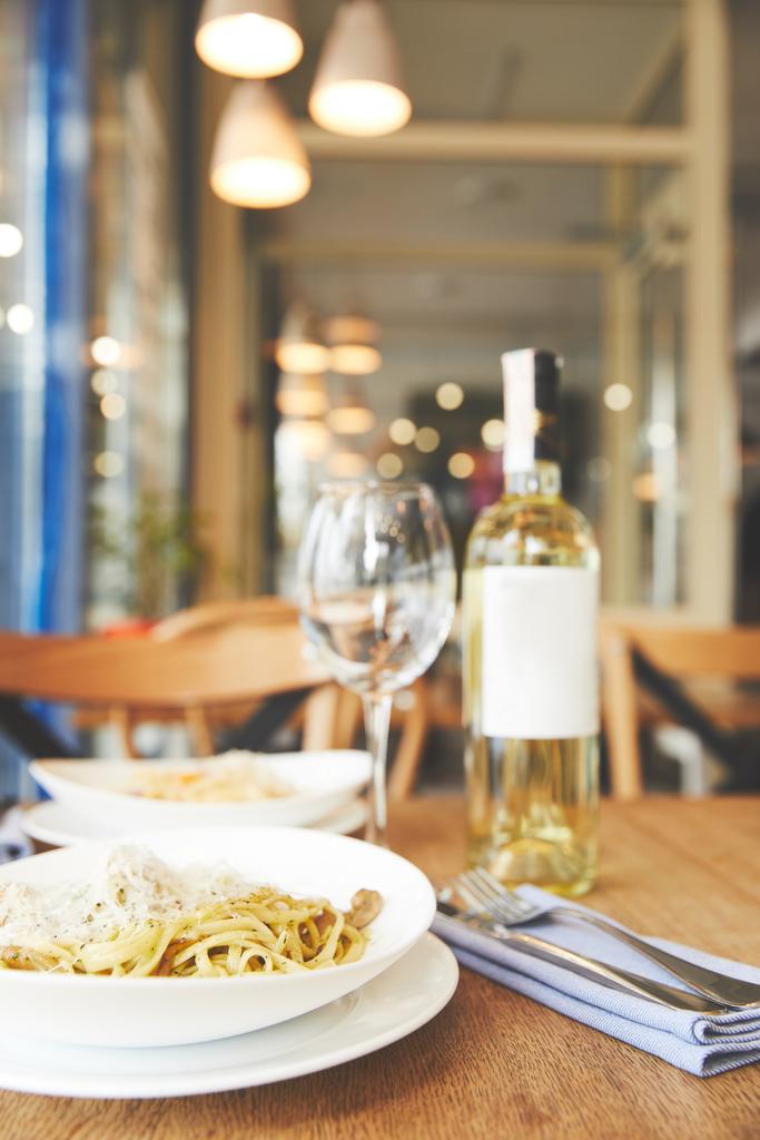 Итальянское блюдо спагетти с песто на столе ресторана
 - Фото, изображение