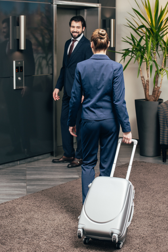 business people with luggage going on elevator together - Photo, Image
