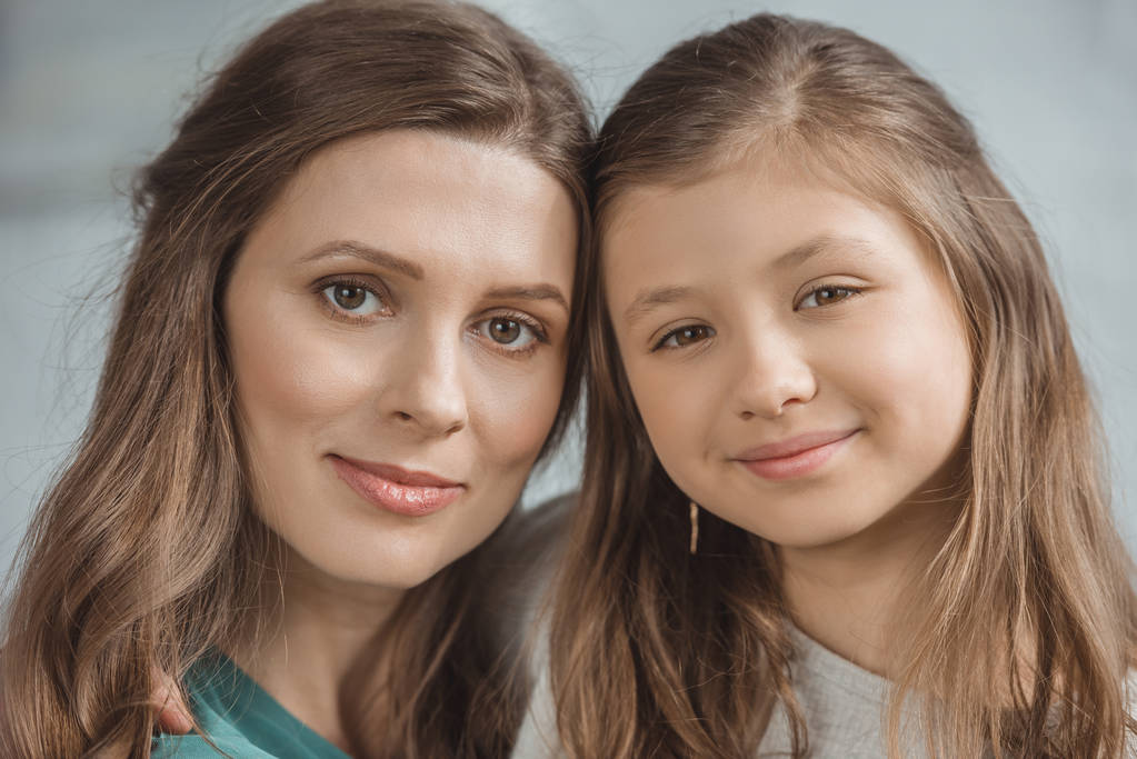 portrait of mother and daughter looking at camera - Photo, Image