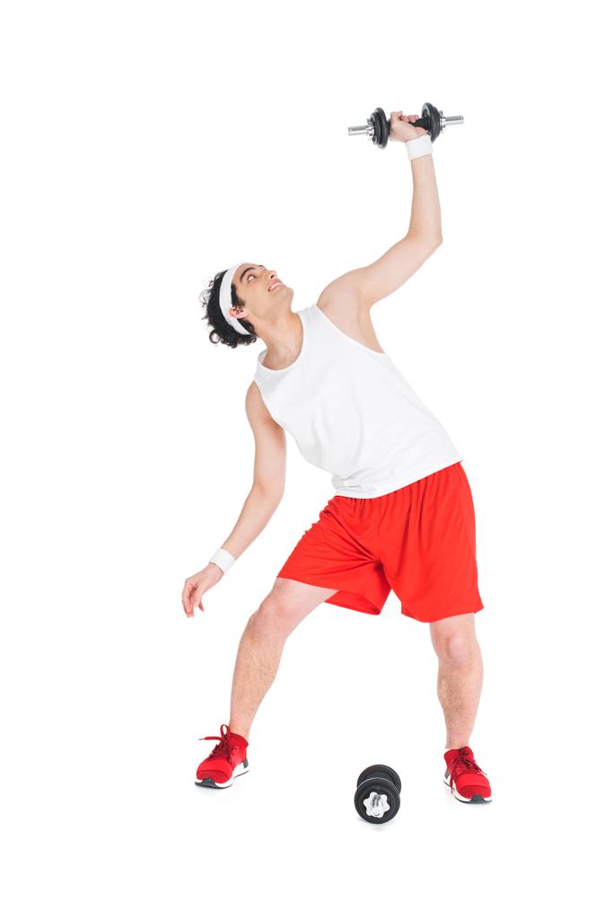 Jeune homme mince en tenue de sport tenant des haltères isolés sur blanc
 - Photo, image