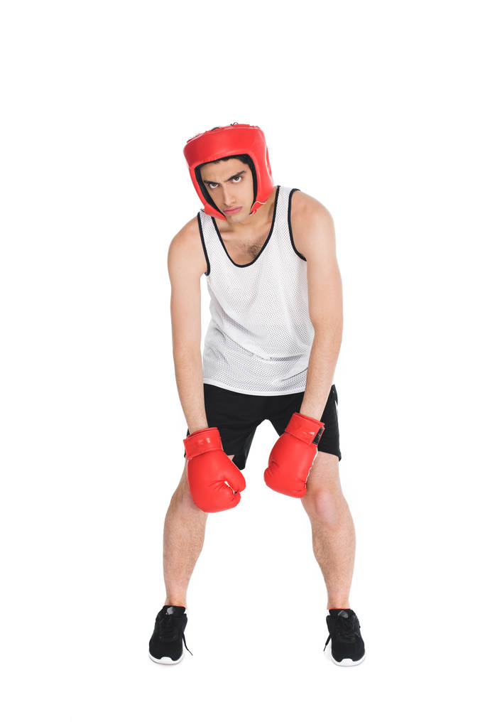 Unavený mladý boxer v rukavice a přilbu izolované na bílém - Fotografie, Obrázek