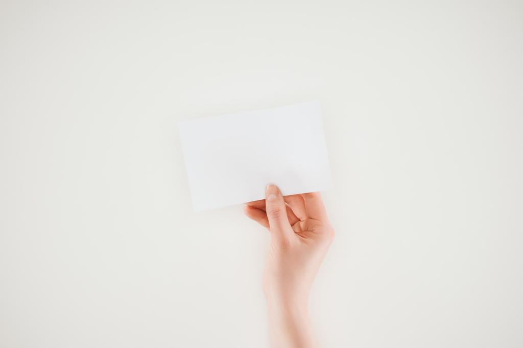 обрезанный снимок женщины, держащей чистый лист бумаги, изолированный на белом
 - Фото, изображение