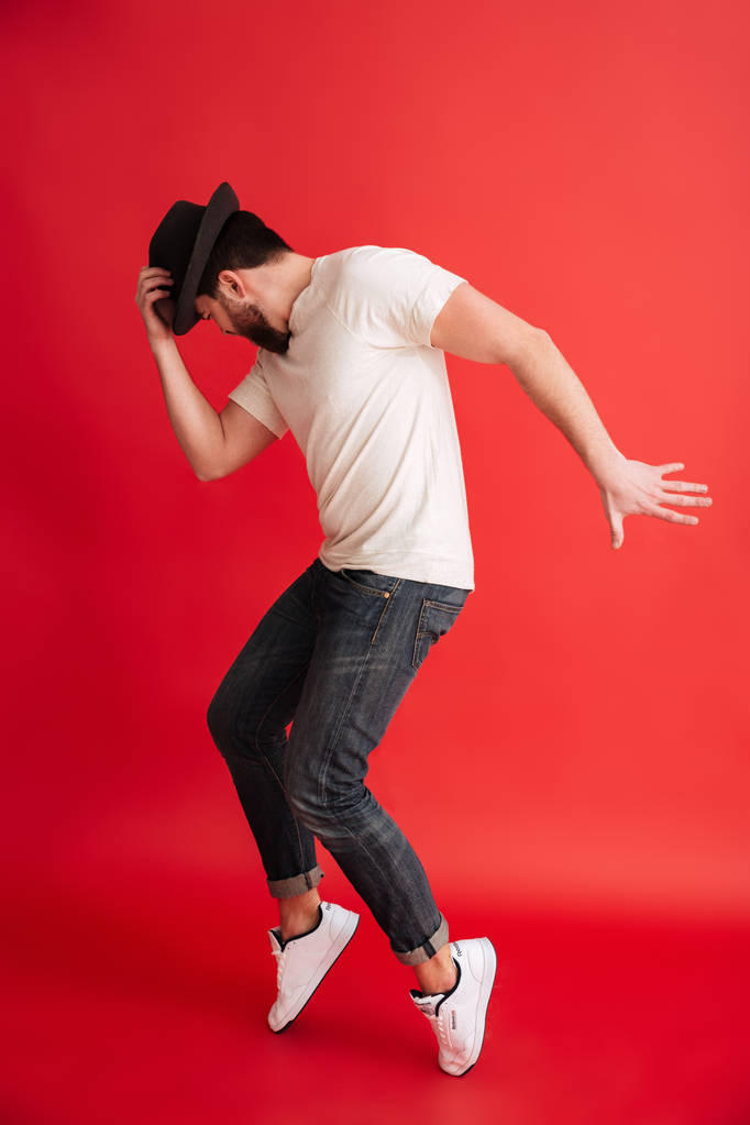Бородатый мужчина танцует в шляпе
. - Фото, изображение