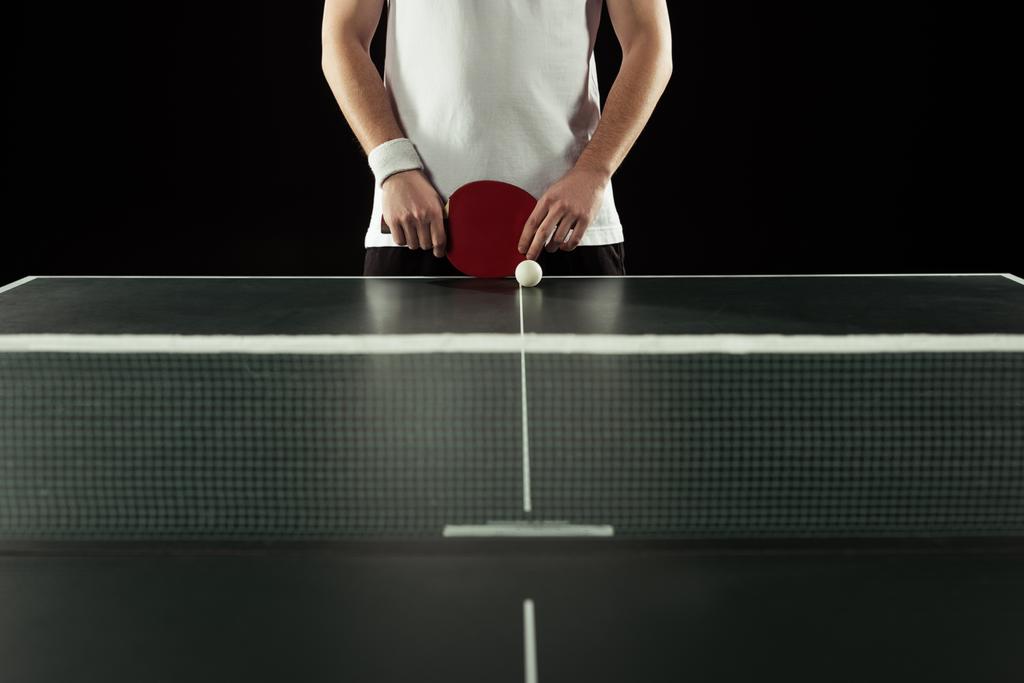 częściowy widok tenisista z stoi rakieta do tenisa stołowego na czarnym tle - Zdjęcie, obraz