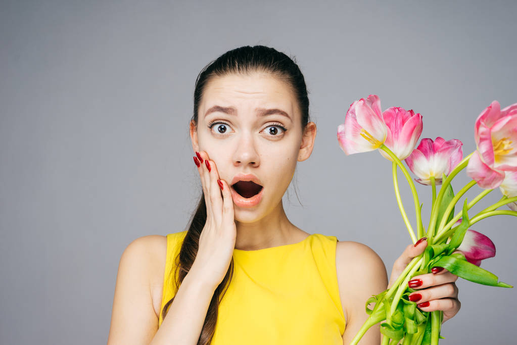 surprised woman holding beautiful flowers, March 8 - Photo, Image