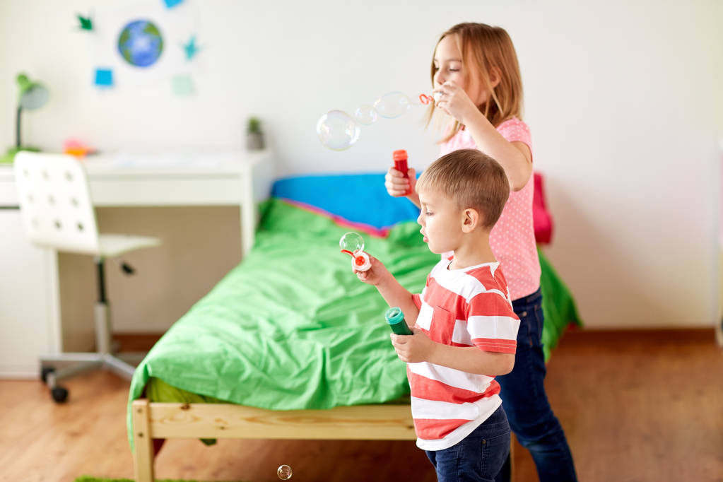 kids blowing soap bubbles and playing at home - Photo, Image